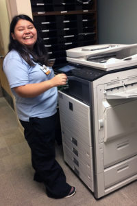 young woman at copy machine