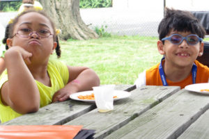 two children at table eating lunch