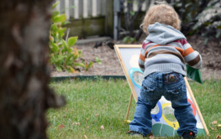 small child playing in garden