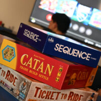 four board games stacked