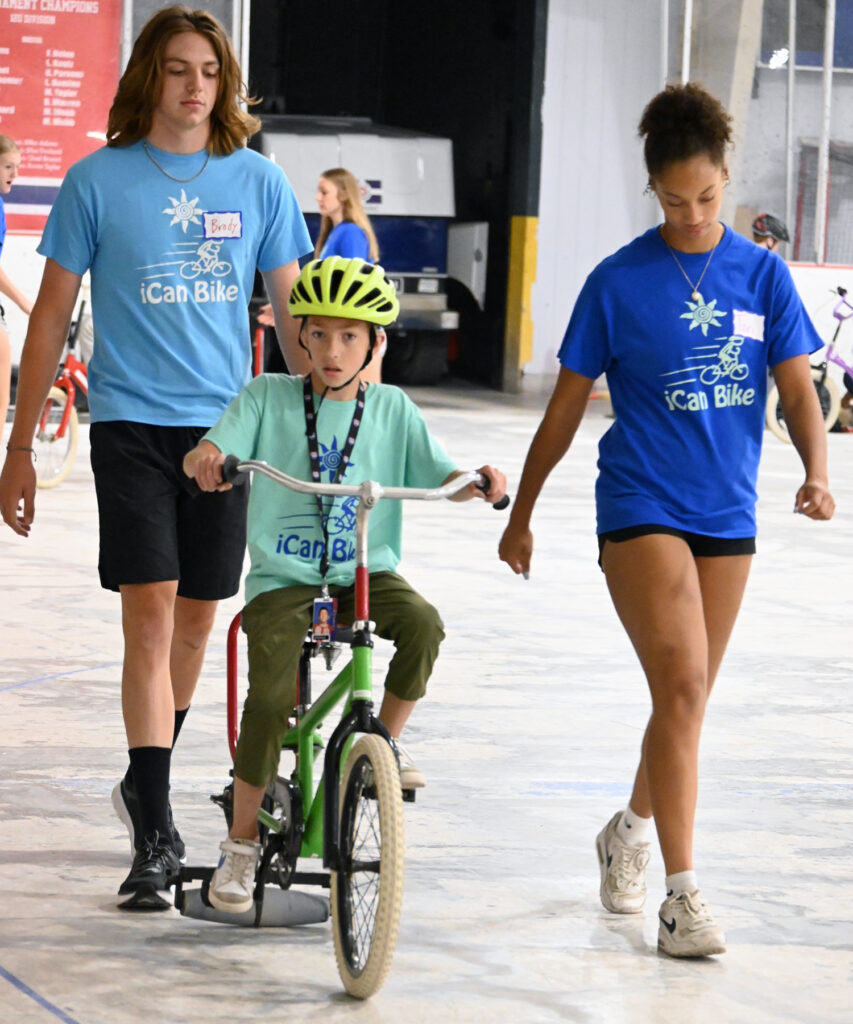 bike rider with two spotters